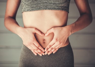 Afro American girl with hands on stomach representing good gut health