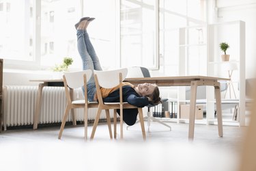Woman doing ab exercises on a chair in a loft
