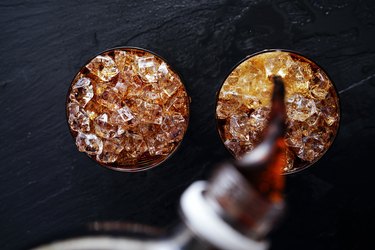 cola soda pop being poured into glass flat lay composition