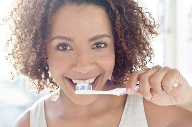 Portrait of woman brushing teeth