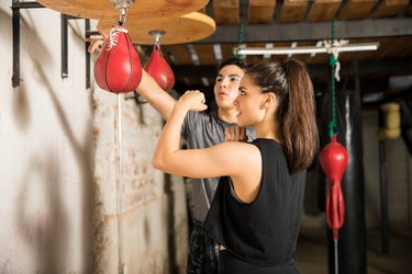 Woman using a speed bag for training