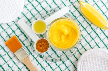 Turmeric and greek yogurt (sour cream or kefir) facial mask with lemon and olive oil. Ingredients for preparing diy face and hair masks and moisturizers. Homemade beauty treatments recipe. Top view.