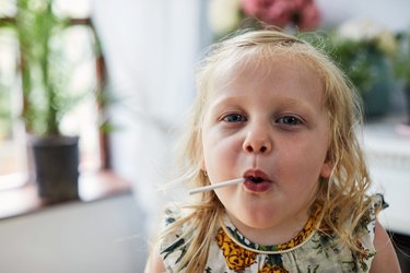 Child eating a lollipop