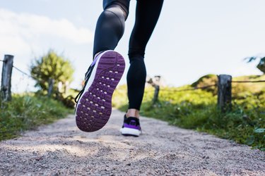 woman jogging on rural road