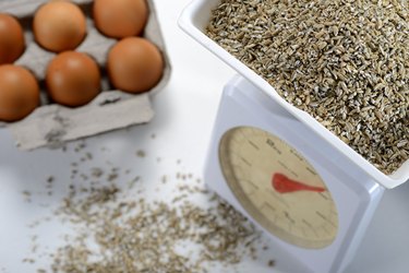 Food scale with crushed rye and eggs