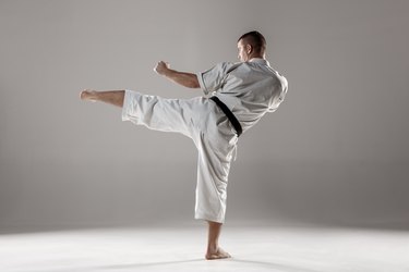 Man in white kimono training karate