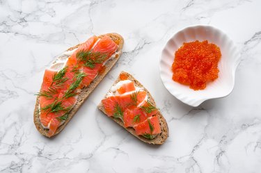 Tasty toast with red salmon and caviar. Top view.