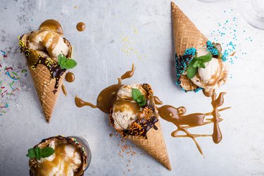 Ice cream with caramel sauce in waffle cone