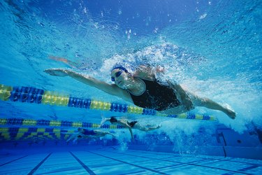 Young Woman Swimming in Pool