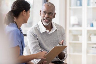 Senior man discusses diagnosis with doctor