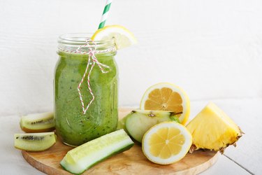 Pineapple cucumber lemon ginger juice on wooden platter for weight loss reviews