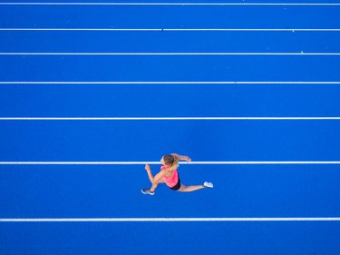 Top view of female runner on tartan track