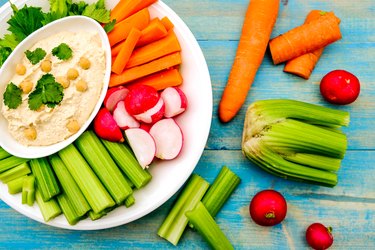 Mediterranean vegetarian hummus dip with fresh vegetables.