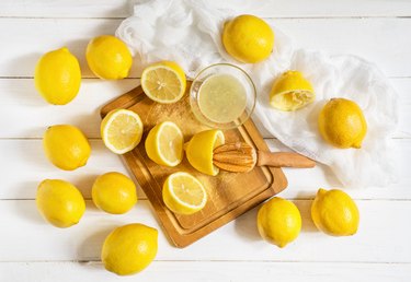 Lemons and citrus squeezer on a wooden background