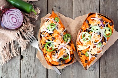 Baked, stuffed sweet potatoes,  above view on rustic wood