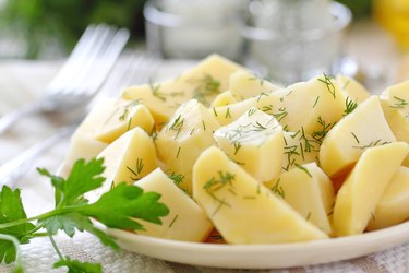 Boiled potatoes with greens and oil