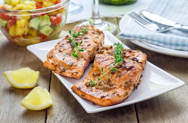 Omega-3-rich grilled salmon with mango-avocado salsa on a white plate