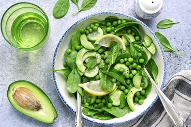 Spring salad with avocado, sweet pea, cucumber and baby spinach.