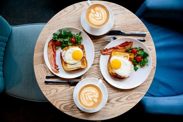 Breakfast with Croque Madame and coffee served for two people in a cafe, high angle view