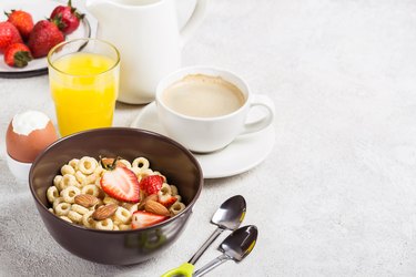 Whole grain rings cheerios, coffee, orange juice and egg. Balanced traditional breakfast