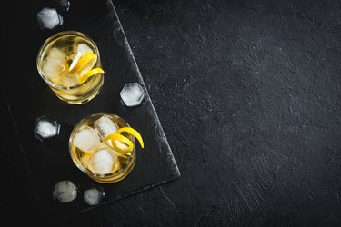 Whiskey on the rocks with lemon peel