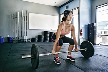 Asian woman strengh training at the gym