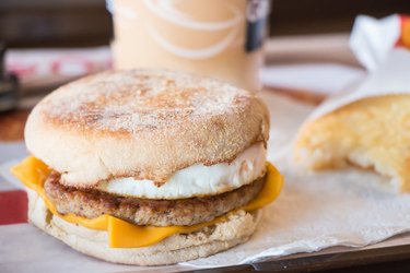 Fried egg on pork with a bagel and cheese