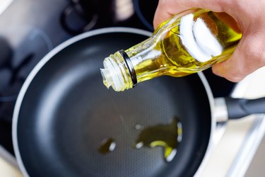 Pouring vegetable oil into a nonstick frying pan
