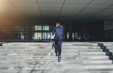 Running up stairs fast man wearing blue suit