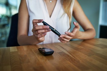 A woman testing her non-fasting glucose levels at home