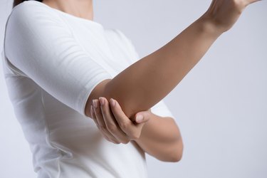 Closeup female's elbow. Arm pain and injury. Health care and medical concept.