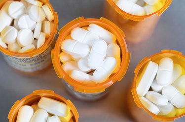 Top view of full prescription bottles on stainless steel background