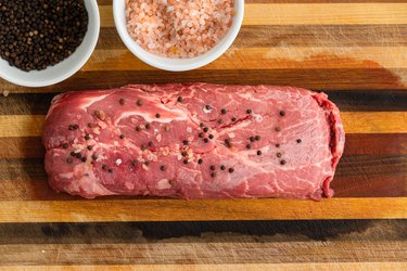 Rectangular slice of steak covered with pepper