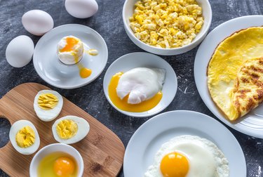 several different styles of cooked eggs on a table, as an example of foods high in lecithin