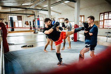 Muay thai boxing athletes training in boxing ring