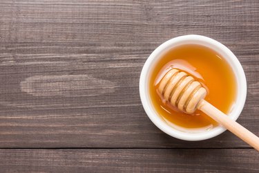 Sweet honey on the wooden table. Top view