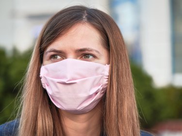 Young woman wearing pink homemade face mask