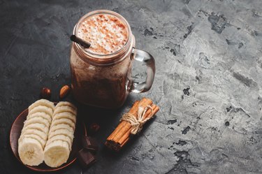 A glass jar filled with creamy chocolate, cannellini bean and cinnamon smoothie