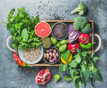 Vegetarian Healthy food ingredients in wooden box over grey background