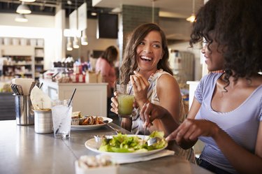 Two Women Enjoying Lunch Date In Delicatessen Restaurant