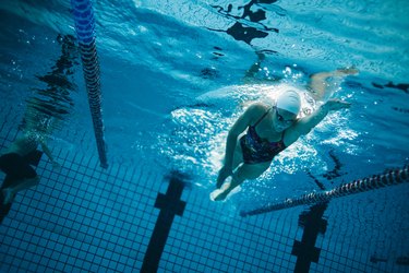 Young female swimmer training in the pool