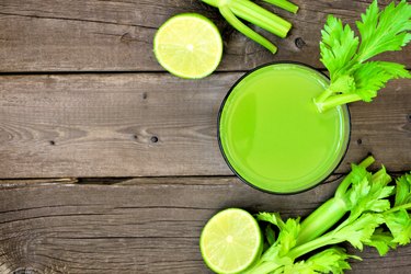 Celery juice, top view over rustic wood with copy space