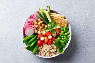 Healthy vegetarian salad. Buddha bowl. Grey stone background. Top view. Close up.