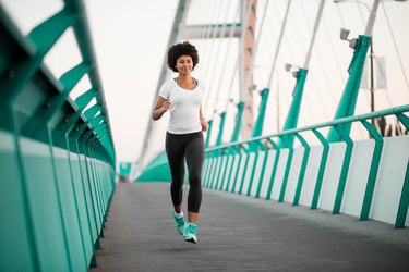 Teen girl exercising on bridge