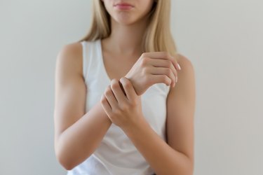 Woman holding painful wrist