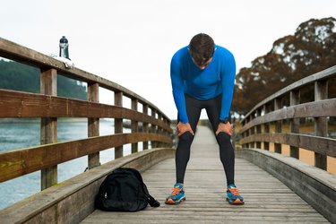 Strong sporty man during workout injured shrinking outdoor suffering depression