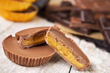 Homemade peanut butter cups on a rustic table for healthy chocolate desserts