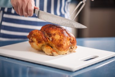 Slicing Rotisserie Chicken on cutting board
