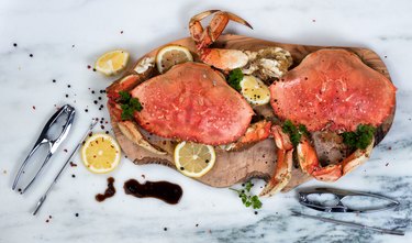 Freshly cooked crab with spices on wooden server