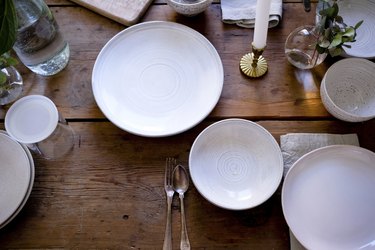 High angle view of empty plates on wooden table at home